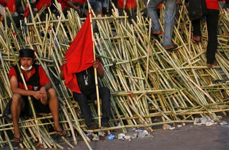Anti-government protesters rest on their handmade bamboo barricade to their encampment on April 21, in Bangkok, Thailand. 